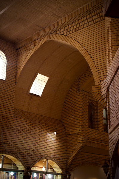 Modern, archaising yellow-brick archwork.